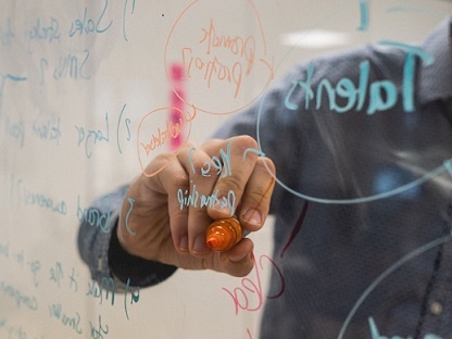 image of person writing on glass (Photo by Kvalifik on Unsplash)